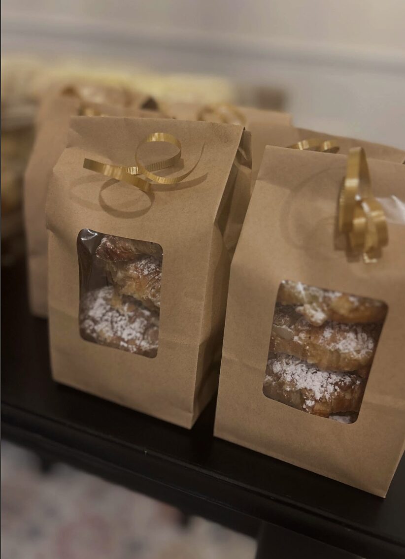 Holiday kraft gift bags tied with ribbon